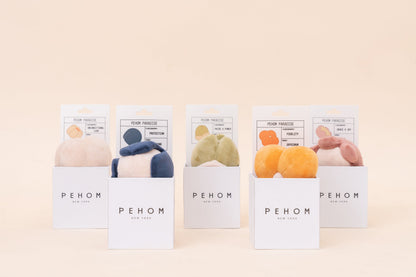 Five packages of PEHOM products on a beige background