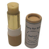 Furry pet balm stick with gold cap and beige container, branded 'BeNat'.