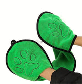 Green mittens with paw design on a white background