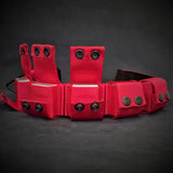Red tactical vest with multiple pockets and straps on a dark background